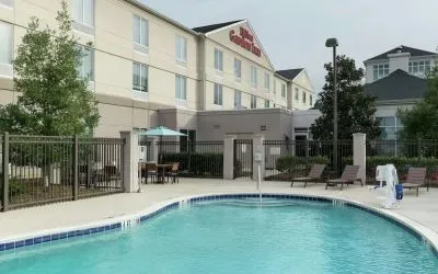 Stunning outdoor pool with pool chairs at Hilton Garden Inn Dothan.