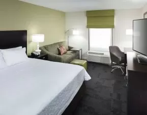 Day use room with work desk and natural light at Hampton Inn & Suites Gainesville-Downtown.