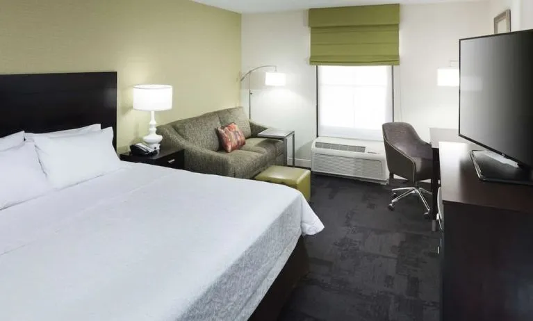 Day use room with work desk and natural light at Hampton Inn & Suites Gainesville-Downtown.