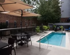 Outdoor pool with seating area at Hampton Inn & Suites Gainesville-Downtown.