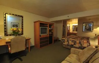 Day use room with work desk and sofa at Shilo Inn Rose Garden.