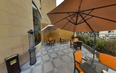 Outdoor terrace and coworking space at Millennium Central Doha.