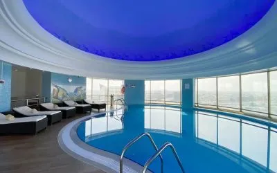 Relaxing indoor pool and pool area at Millennium Hotel Doha.