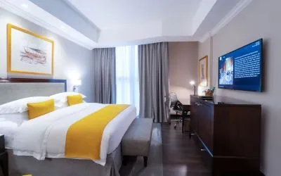King bed with TV at Millennium Hotel Doha.