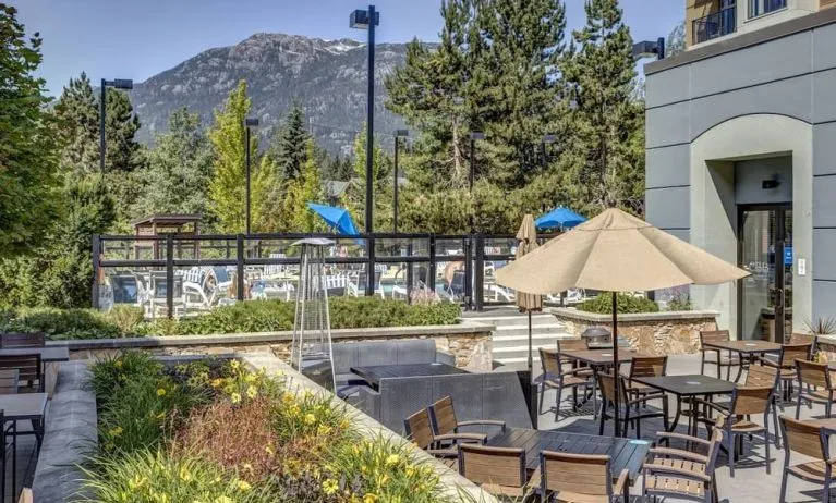 Outdoor terrace set in a lovely garden at Hilton Whistler Resort & Spa.