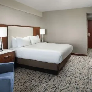 King bed with TV and work desk at Hilton Boston Logan Airport.