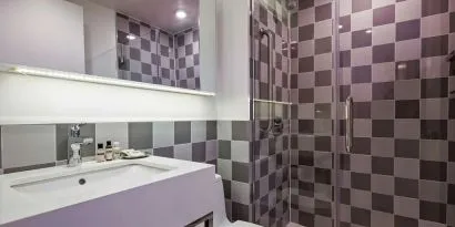 Guest bathroom with shower at Best Western Premier Empire State Hotel.