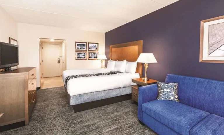 Day use room with TV and sofa at La Quinta Inn & Suites By Wyndham Philadelphia Airport.