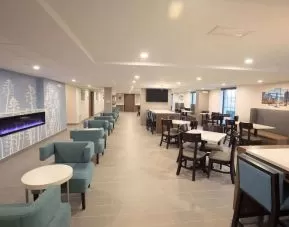 Dining area and coworking space at Sleep Inn Oakbrook Terrace.
