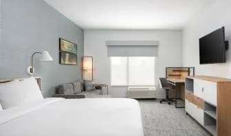 Bright-lit day use room with work desk and sofa at TownePlace Suites Nashville Midtown.