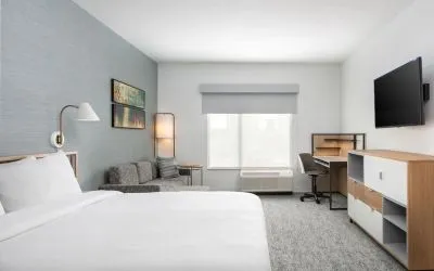 Bright-lit day use room with work desk and sofa at TownePlace Suites Nashville Midtown.