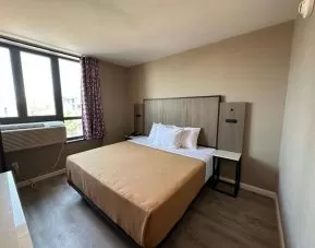 King room with natural light at Regal Inn & Suites New York.