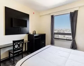 Delux king room with TV at Astoria Inn LaGuardia Hotel.