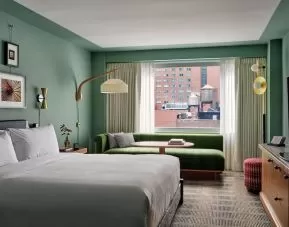 Day room with kitchenette and lounge area at Romer Hell's Kitchen.