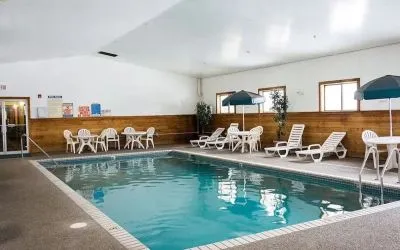 Indoor pool with pool chairs at Norwood Inn & Suites - Roseville.