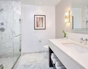 Bathroom with shower at Ko'a Kea Resort On Po`ipu Beach.