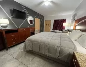 King bed with TV at Casa Rosa Inn.