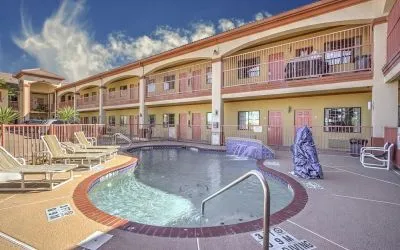 Relaxing pool area with loungers at Casa Rosa Inn.