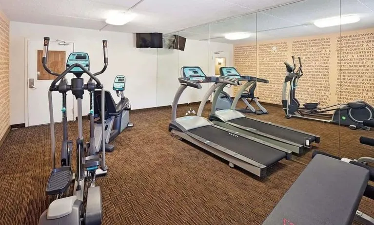Fitness center at Norwood Inn Statefare Grounds.