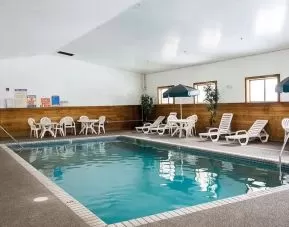 Outdoor pool with lounge chairs at Norwood Inn Minneapolis Roseville.