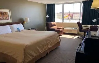 Day use room with work desk and natural light at Norwood Inn & Suites La Crosse.