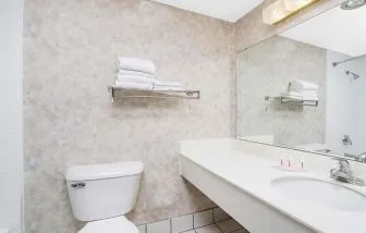 Private guest bathroom with shower and free toiletries at Norwood Inn & Suites La Crosse.
