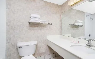 Private guest bathroom with shower and free toiletries at Norwood Inn & Suites La Crosse.