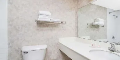 Private guest bathroom with shower and free toiletries at Norwood Inn & Suites La Crosse.