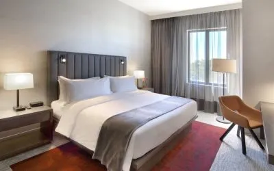 Delux king bed with TV and business desk at Fairfield Inn & Suites By Marriott Kenosha Pleasant Prairie.