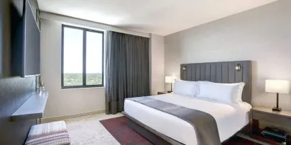 King bed with lounge area and natural light at Fairfield Inn & Suites By Marriott Kenosha Pleasant Prairie.