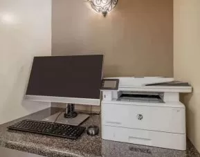 Hotel business center workstation, including monitor, keyboard, mouse, and printer.