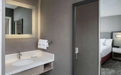 Sonesta Select Nashville Airport Suites double bed guest room, with ensuite bathroom.