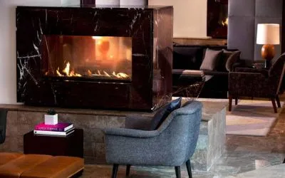 Royal Sonesta Washington DC Dupont Circle’s lobby lounge is furnished with comfortable seating, coffee tables, and a fireplace.