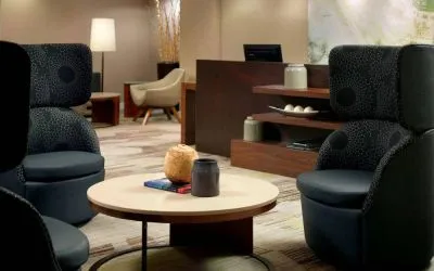 Sonesta Select Atlanta Cumberland Galleria’s lobby lounge is furnished with comfortable chairs and coffee tables.