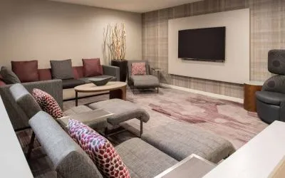 The lobby in Sonesta Select Seattle Bellevue Redmond features an enormous television, comfortable seating and coffee tables.