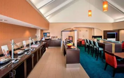 The breakfast area in Sonesta ES Suites Allentown Bethlehem Airport has a mix of table and tall stool seating, and a range of healthy eating options.