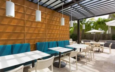 The hotel patio features tables and chairs where guests can relax and socialize in the open air.