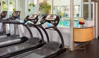 The hotel fitness center has numerous exercise machines and is adjacent to the indoor pool.