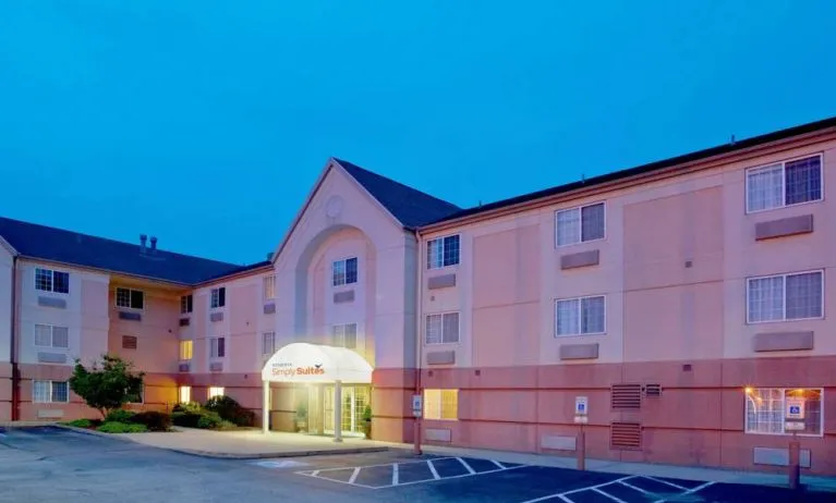 Sonesta Simply Suites Pittsburgh Airport’s exterior includes a covered entrance, pleasant greenery, and parking spaces.
