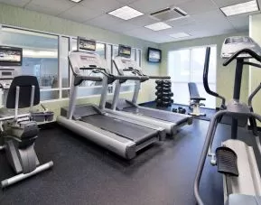 Sonesta Select Seattle Renton’s fitness center is equipped with both free weights and a variety of exercise machines, and has large windows.