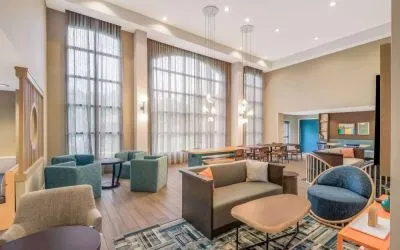 The hotel’s lobby lounge has a high ceiling and full-length windows, comfortable seating including armchairs and sofas, and numerous coffee tables.