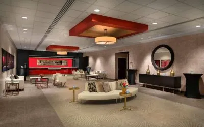 The lounge in Sonesta Philadelphia Rittenhouse Square’s lobby is furnished with sofas and comfy chairs, numerous coffee tables, and is a spacious setting.