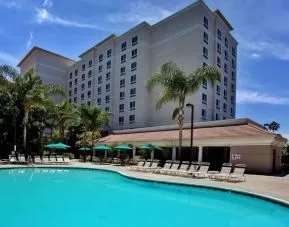 Outdoor pool with pool chairs at Sonesta Anaheim Resort Area.