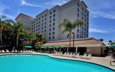Outdoor pool with pool chairs at Sonesta Anaheim Resort Area.