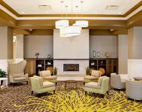 The hotel’s lobby lounge includes a fireplace, armchairs and coffee tables set in a spacious environment.