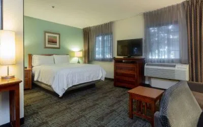 Double bed guest room in Sonesta ES Suites Anaheim Resort Area, including two windows, coffee table, and a television.