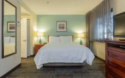 Sonesta ES Suites Anaheim Resort Area double bed guest room, featuring art on the wall, TV, and a window.