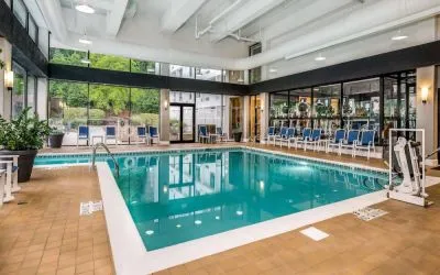 The hotel’s indoor pool includes a lift, has chairs by the side, and large windows to let in plenty of natural light.