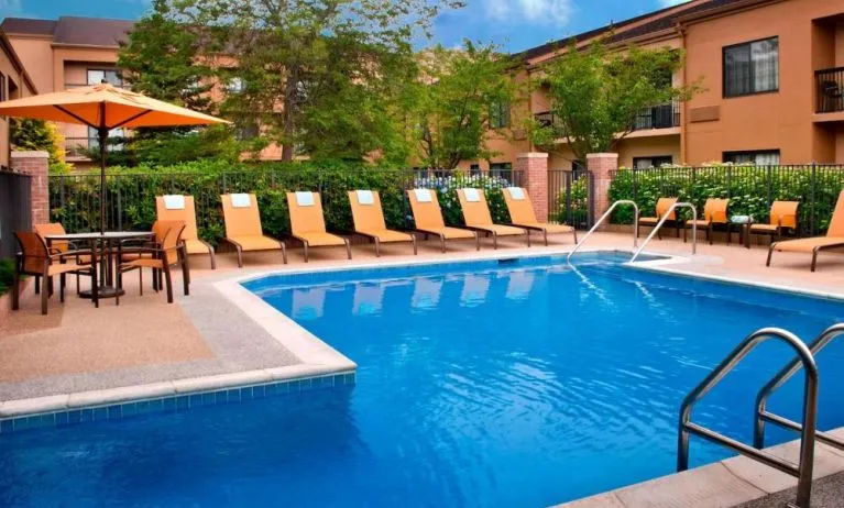 The hotel’s outdoor pool has a direct water link to the indoor pool, and has a shaded table and chairs as well as sun loungers by the side.