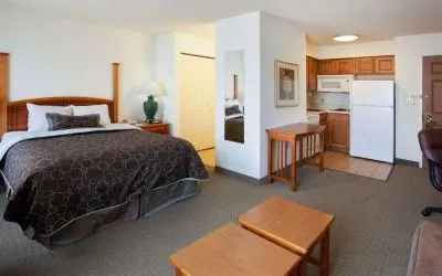 Double bed guest room in Sonesta ES Suites San Antonio Northwest - Medical Center, featuring kitchen area with fridge-freezer and microwave.